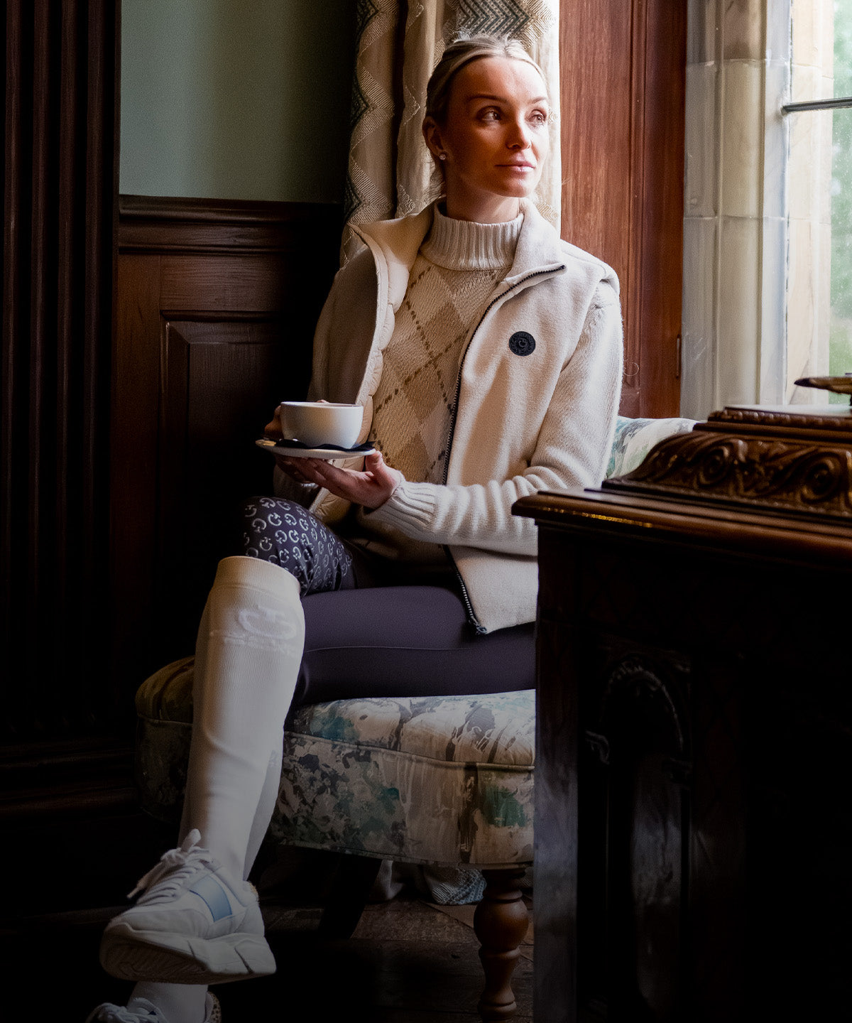 Woman Wearing Cavalleria Toscana Pure Wool Turtleneck Sweater - Rombi/Rainy Day, Sat In A Window With A Coffee